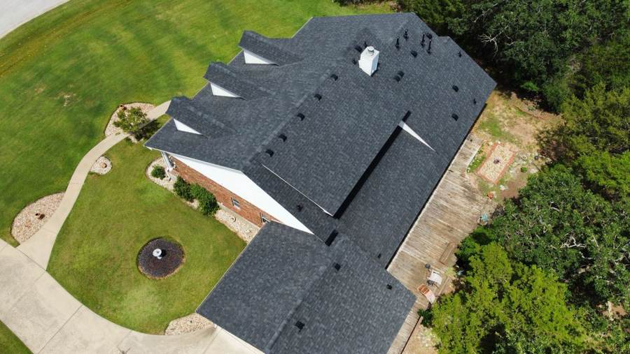 New charcoal shingle roof with three dormers, seen from above